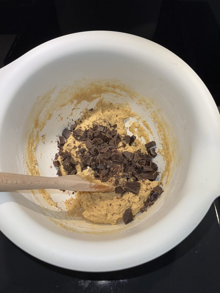 Chocolate chip cookie dough in a mixing bowl before the chocolate is incorporated